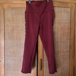 Maroon alo leggings with mesh and crisscross detail siding